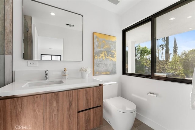 bathroom featuring toilet, recessed lighting, visible vents, and vanity