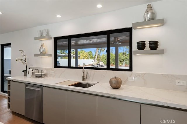 kitchen with stainless steel dishwasher, open shelves, a healthy amount of sunlight, and a sink