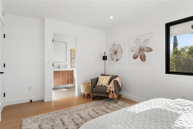 bedroom featuring recessed lighting, light wood-type flooring, connected bathroom, and baseboards