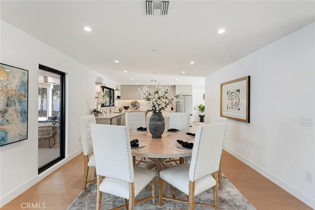 dining room with recessed lighting, light wood finished floors, baseboards, and visible vents