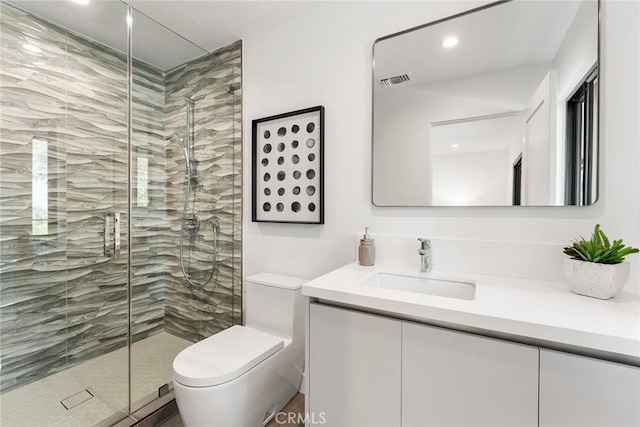 full bath with vanity, toilet, recessed lighting, a shower stall, and visible vents