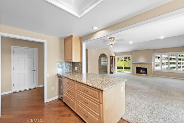 kitchen featuring wine cooler, light brown cabinets, a ceiling fan, baseboards, and backsplash