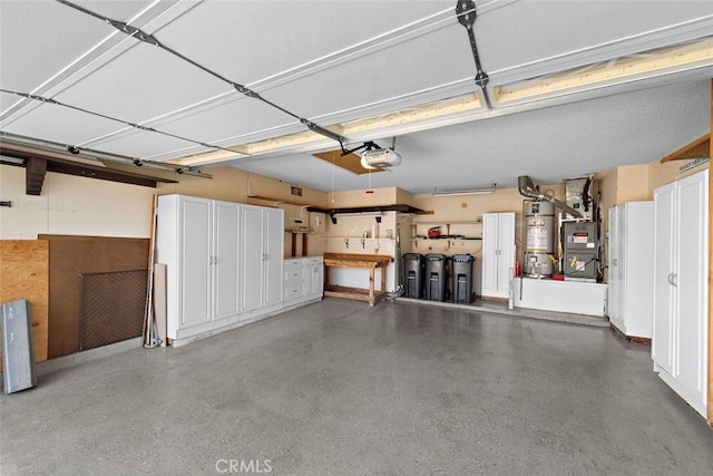 garage with strapped water heater, heating unit, and a garage door opener