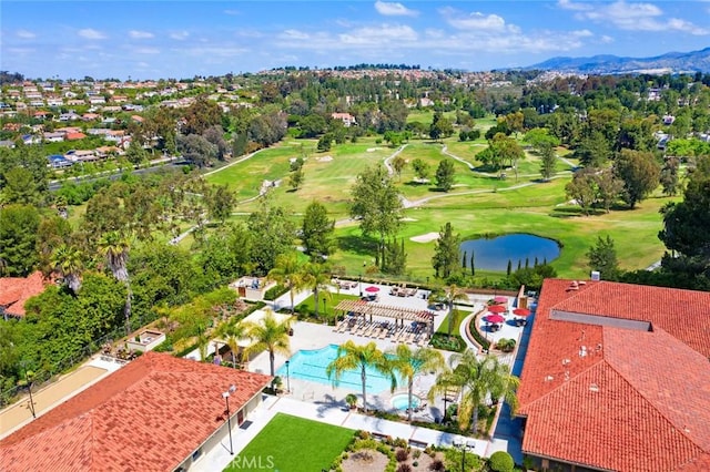 birds eye view of property with view of golf course and a water view