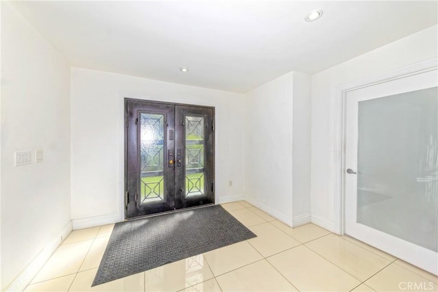 tiled foyer entrance featuring recessed lighting, baseboards, and french doors