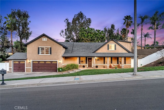 7384 Golden Star Ave, Riverside, CA 92506 - view of front of home featuring a porch, fence, driveway, and stucco siding