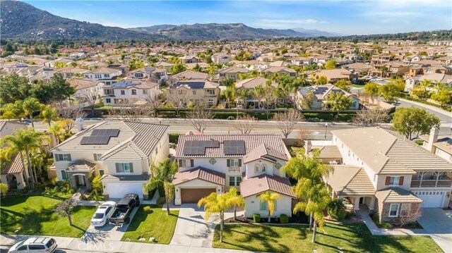 birds eye view of property with a mountain view and a residential view