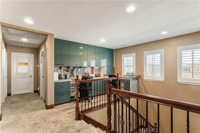 kitchen featuring recessed lighting, light colored carpet, visible vents, baseboards, and green cabinets