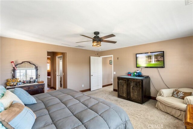 bedroom with baseboards, visible vents, a ceiling fan, and light colored carpet