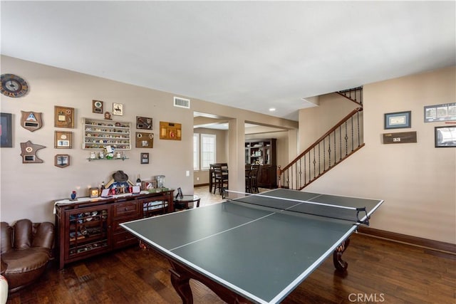 recreation room with visible vents, baseboards, and wood finished floors