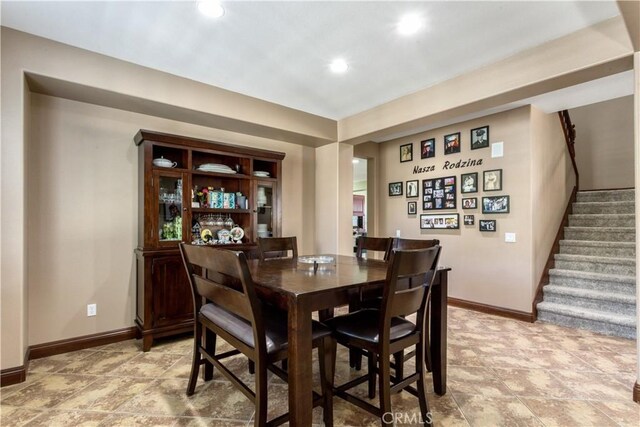 dining room featuring stairs, recessed lighting, and baseboards