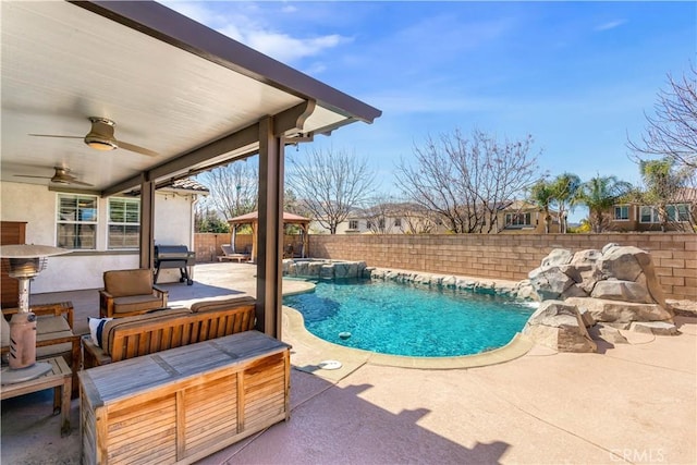 view of pool featuring a patio area, a fenced backyard, a pool with connected hot tub, and ceiling fan