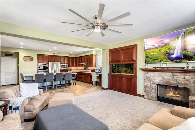 living area featuring recessed lighting, a fireplace, a ceiling fan, baseboards, and visible vents