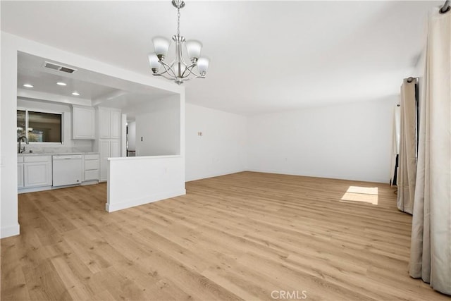 interior space featuring light wood-style flooring, a sink, visible vents, recessed lighting, and a chandelier
