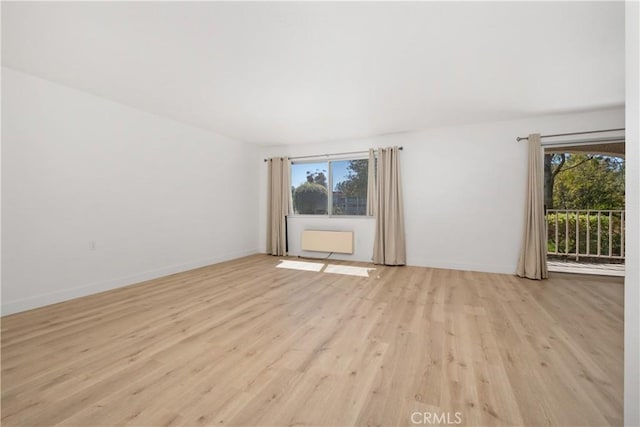 unfurnished room featuring light wood-style flooring and baseboards
