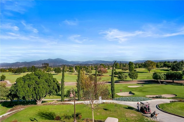 view of home's community featuring a yard, a mountain view, and golf course view