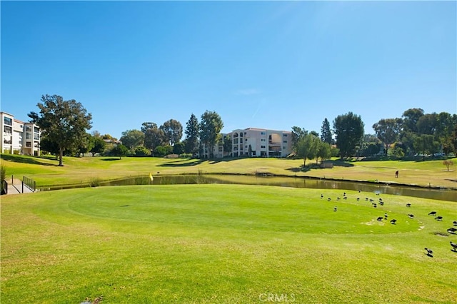 view of property's community featuring view of golf course and a water view