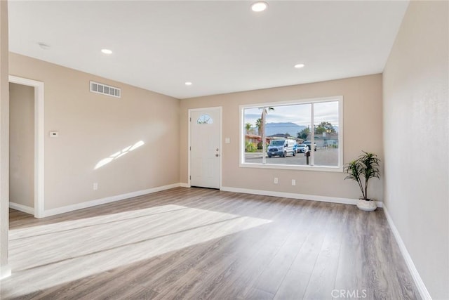 entrance foyer with recessed lighting, visible vents, baseboards, and wood finished floors