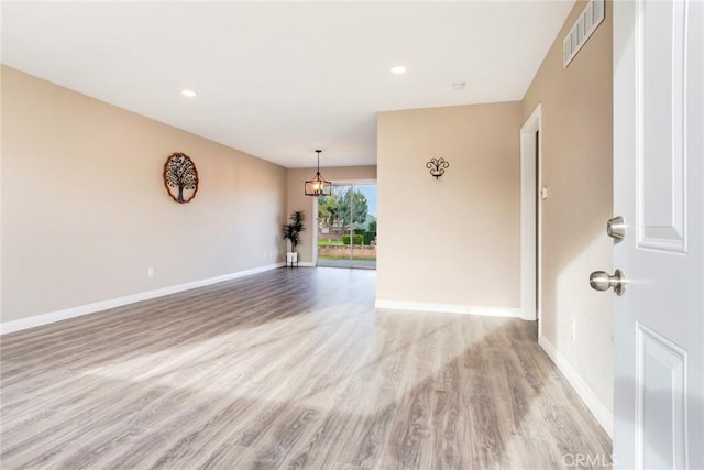 spare room with light wood-type flooring, visible vents, baseboards, and recessed lighting