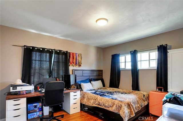 bedroom with wood finished floors