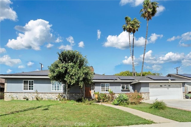 single story home featuring a garage, driveway, stone siding, stucco siding, and a front yard