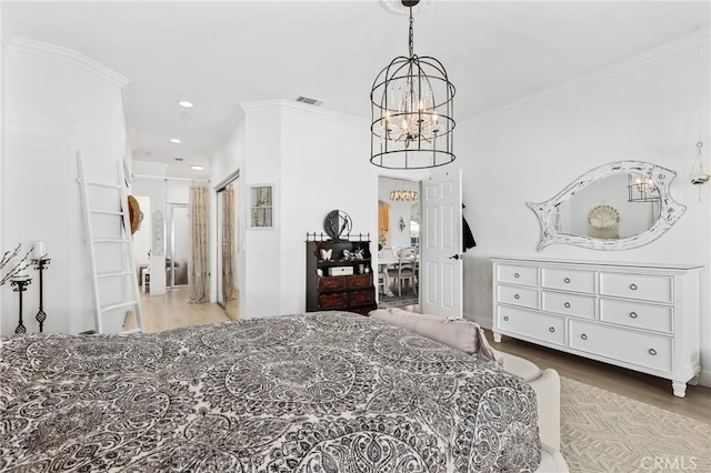 bedroom featuring visible vents, wood finished floors, an inviting chandelier, crown molding, and recessed lighting