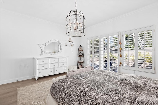 bedroom featuring a notable chandelier, wood finished floors, baseboards, access to exterior, and crown molding