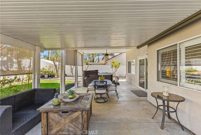 view of patio featuring an outdoor hangout area, a hot tub, and fence