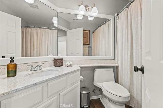 full bathroom with visible vents, toilet, wood finished floors, and vanity