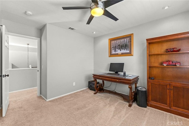 office space featuring a ceiling fan, carpet flooring, baseboards, and visible vents