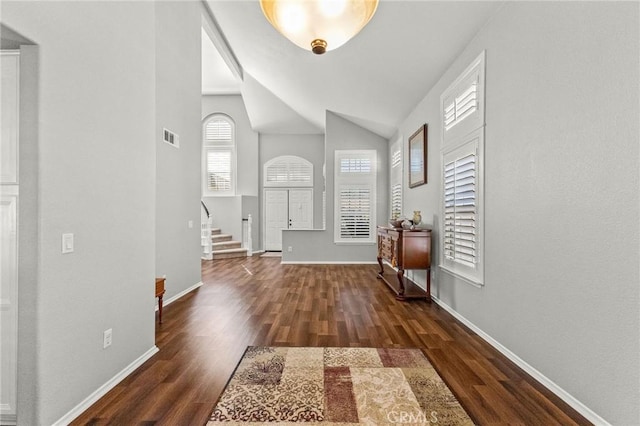 foyer entrance featuring stairs, wood finished floors, visible vents, and baseboards