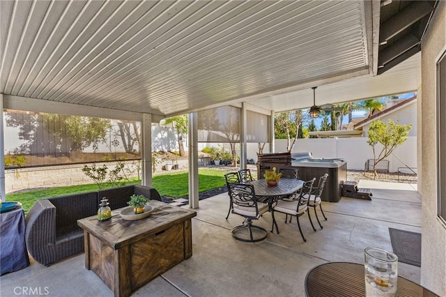 view of patio / terrace featuring an outdoor hangout area, a fenced backyard, outdoor dining space, and a hot tub