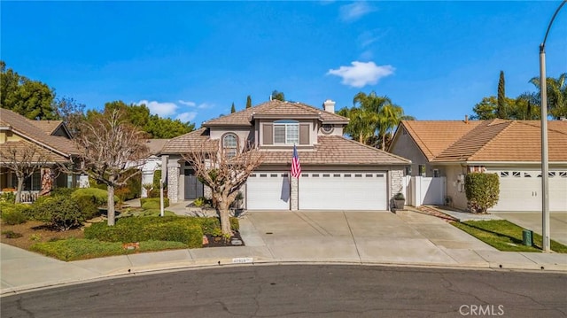 view of front of house with fence, a tile roof, stucco siding, a garage, and driveway