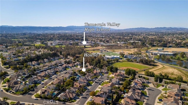 drone / aerial view with a residential view and a water and mountain view