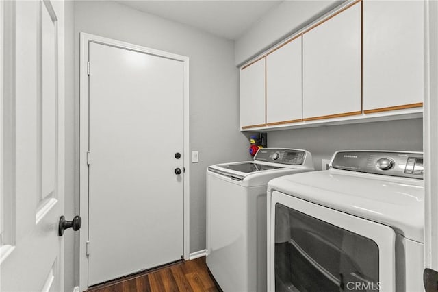 washroom with dark wood-style floors, cabinet space, and independent washer and dryer