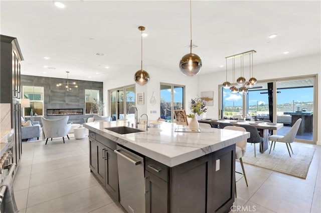 kitchen featuring stainless steel dishwasher, a kitchen breakfast bar, recessed lighting, and a sink