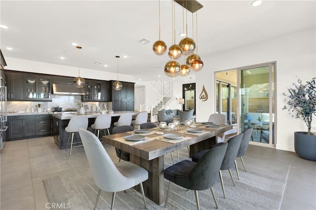 dining area featuring light tile patterned floors, recessed lighting, visible vents, and stairs