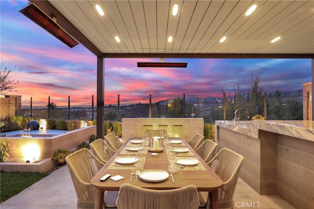 patio terrace at dusk with outdoor dining space