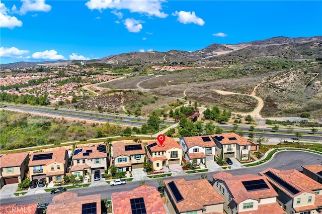 birds eye view of property with a mountain view and a residential view