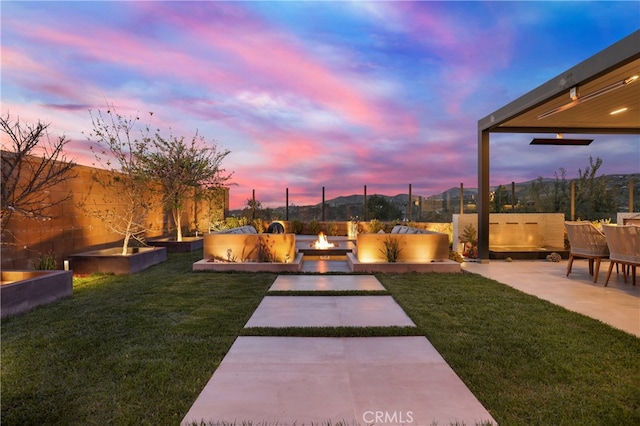 view of yard with a fenced backyard, a patio, and a fire pit