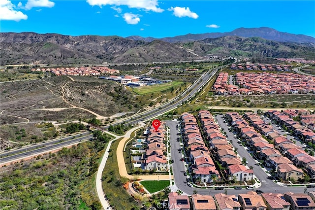 drone / aerial view featuring a residential view and a mountain view