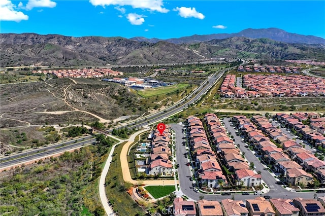 birds eye view of property with a mountain view and a residential view