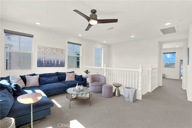 living area with carpet flooring, visible vents, and recessed lighting