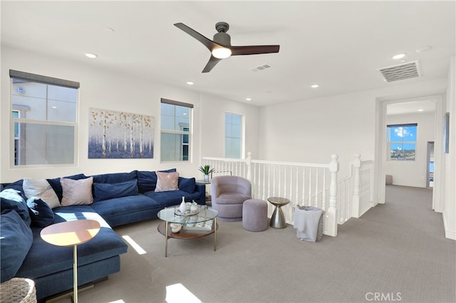 carpeted living room featuring a ceiling fan, recessed lighting, and visible vents