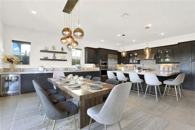 dining room featuring plenty of natural light, beverage cooler, visible vents, and recessed lighting