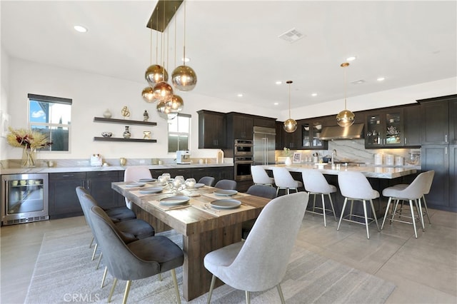 dining area featuring recessed lighting, beverage cooler, visible vents, and a healthy amount of sunlight