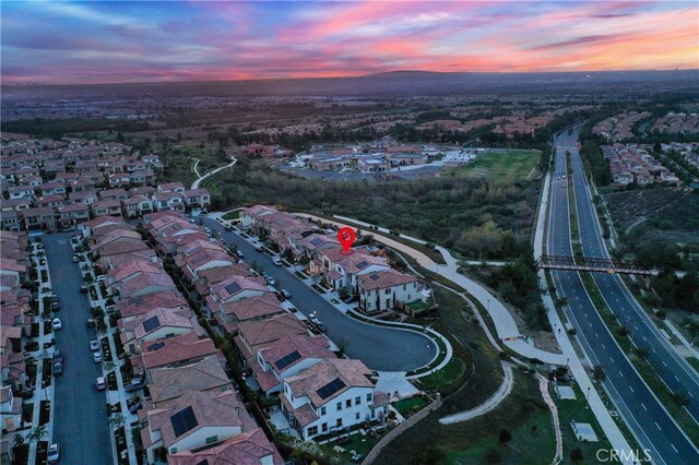 aerial view at dusk featuring a residential view