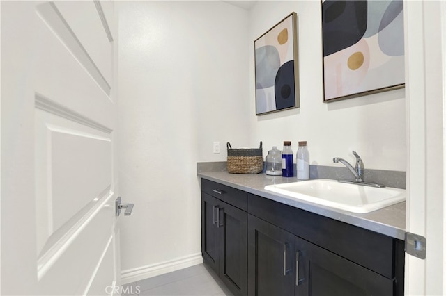 bathroom with tile patterned flooring, vanity, and baseboards