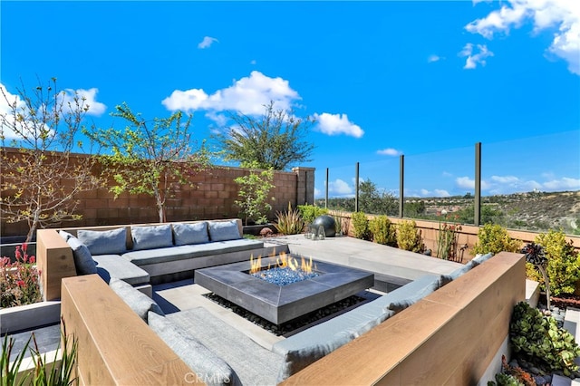 view of patio / terrace featuring an outdoor living space with a fire pit and a fenced backyard