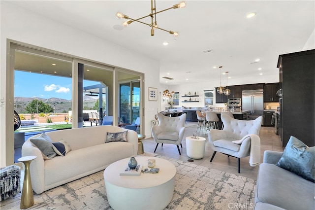 living area featuring a mountain view, a notable chandelier, and recessed lighting